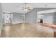 Spacious and bright living room leading into a kitchen with white cabinets at 1681 Graystone Dr, Hampton, GA 30228