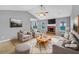 Cozy staged living room featuring a brick fireplace, neutral decor, and lots of natural light at 1681 Graystone Dr, Hampton, GA 30228