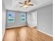 Bright main bedroom with tray ceiling, wood floors, ensuite bathroom, and bright double windows at 1681 Graystone Dr, Hampton, GA 30228