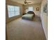 Large carpeted bedroom featuring a ceiling fan, two windows, and two entry doors at 2371 Bellefonte Ave # 61, Lawrenceville, GA 30043