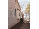 Brick home exterior shows a bay window, black shutters, and a side yard with mature trees at 2371 Bellefonte Ave # 61, Lawrenceville, GA 30043