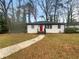 Charming single-story home featuring a bright red front door and a well-manicured lawn at 2046 Dellwood Pl, Decatur, GA 30032