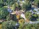 An aerial perspective capturing a home nestled amongst lush trees, boasting a generous yard and lengthy driveway at 427 Picketts Lake Dr, Acworth, GA 30101