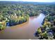 A scenic aerial view of a calm lake surrounded by a lush green forest at 427 Picketts Lake Dr, Acworth, GA 30101