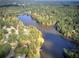 An aerial view featuring a lakefront community with mature trees at 427 Picketts Lake Dr, Acworth, GA 30101