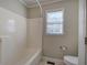 Bathroom with a large bathtub, toilet, and window providing natural light at 427 Picketts Lake Dr, Acworth, GA 30101