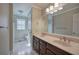 Bathroom featuring a double sink vanity with marble floors and plenty of lighting at 427 Picketts Lake Dr, Acworth, GA 30101