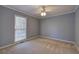 A bright bedroom with a ceiling fan and a large window provides natural light at 427 Picketts Lake Dr, Acworth, GA 30101