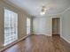 Sunlit room with hardwood floors, neutral walls, ceiling fan, and two bright windows at 427 Picketts Lake Dr, Acworth, GA 30101