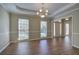 Elegant dining room featuring hardwood floors, chandelier, and natural light streaming through windows at 427 Picketts Lake Dr, Acworth, GA 30101