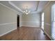 Elegant dining room featuring hardwood floors, tray ceiling, chandelier, and ample natural light at 427 Picketts Lake Dr, Acworth, GA 30101