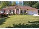 Charming single story home with manicured lawn, mature landscaping, and an attached two car garage at 427 Picketts Lake Dr, Acworth, GA 30101