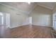 Spacious living room with vaulted ceiling, wood flooring, and access to other rooms in the home at 427 Picketts Lake Dr, Acworth, GA 30101