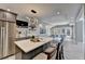 Stylish bar area with modern lighting, stainless steel fridge, and bar stools for entertaining at 4634 Meadow Bluff Ln, Suwanee, GA 30024