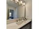 Bright bathroom vanity featuring a marble countertop, modern faucet, and stylish lighting at 4634 Meadow Bluff Ln, Suwanee, GA 30024