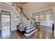 Elegant foyer featuring staircase, hardwood floors, high ceilings, and a seamless transition to living spaces at 4634 Meadow Bluff Ln, Suwanee, GA 30024