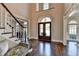 Grand foyer with soaring ceilings, hardwood floors, elegant staircase and large front entrance at 4634 Meadow Bluff Ln, Suwanee, GA 30024