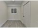 Hallway with light gray floors, white walls, and a white entry door at 4634 Meadow Bluff Ln, Suwanee, GA 30024