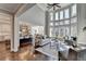 Bright living room with floor to ceiling windows, and an open floor plan to the kitchen at 4634 Meadow Bluff Ln, Suwanee, GA 30024