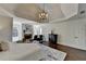 Bright main bedroom featuring a tray ceiling, fireplace, sitting area, and hardwood floors at 4634 Meadow Bluff Ln, Suwanee, GA 30024