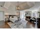 Comfortable main bedroom with tray ceiling, fireplace, sitting area, and hardwood floors at 4634 Meadow Bluff Ln, Suwanee, GA 30024