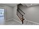 An interior staircase featuring wood railing, white trim, and gray walls at 4634 Meadow Bluff Ln, Suwanee, GA 30024