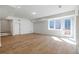 Spacious basement featuring light hardwood floors, white walls, and natural light at 165 Cedarwood Ln, Roswell, GA 30075