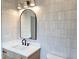 Modern bathroom features a stylish mirror and a vanity with a sleek countertop at 165 Cedarwood Ln, Roswell, GA 30075