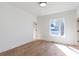 Bright bedroom featuring light hardwood floors, white walls, and large picture window at 165 Cedarwood Ln, Roswell, GA 30075