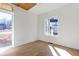 Bright bedroom with hardwood floors, white walls, and large windows for ample natural light at 165 Cedarwood Ln, Roswell, GA 30075