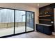 Large sliding glass doors leading to the deck with built-in cabinets at 165 Cedarwood Ln, Roswell, GA 30075