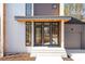 Contemporary home entrance with a covered porch, multiple windows, and sleek design elements at 165 Cedarwood Ln, Roswell, GA 30075