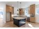 Spacious kitchen with island features natural wood cabinets and stainless steel appliances, blending style and function at 165 Cedarwood Ln, Roswell, GA 30075