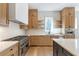 Well-equipped kitchen with stainless steel appliances, wood cabinetry, and quartz countertops at 165 Cedarwood Ln, Roswell, GA 30075