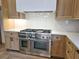Modern kitchen features stainless steel appliances and natural wood cabinetry, perfect for cooking enthusiasts at 165 Cedarwood Ln, Roswell, GA 30075
