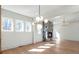 Bright living room with a stone fireplace, modern lighting, and multiple windows at 165 Cedarwood Ln, Roswell, GA 30075