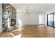 Bright living room featuring a stone fireplace, modern lighting, and hardwood floors at 165 Cedarwood Ln, Roswell, GA 30075