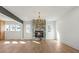 Open-concept living room with stone fireplace, hardwood floors, and ample natural light at 165 Cedarwood Ln, Roswell, GA 30075