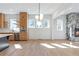 Bright living room with hardwood floors, many windows, a fireplace, and stylish modern light fixture at 165 Cedarwood Ln, Roswell, GA 30075