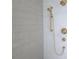 A modern shower with vertical tiling and bronze shower head at 165 Cedarwood Ln, Roswell, GA 30075