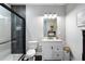 Modern bathroom with tile shower, sleek vanity, and stylish lighting for a spa-like experience at 2447 Tift Nw Ct, Kennesaw, GA 30152