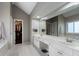Bathroom featuring a double vanity, large mirror, and access to walk-in closet at 2447 Tift Nw Ct, Kennesaw, GA 30152