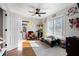 Bright bedroom with ceiling fan, hardwood floors, a large window, and playroom decor at 2447 Tift Nw Ct, Kennesaw, GA 30152