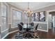 Elegant dining area with modern chandelier, stylish furniture, and large sunny windows at 2447 Tift Nw Ct, Kennesaw, GA 30152