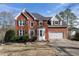 Beautiful two-story brick home featuring an attached two-car garage and manicured front yard at 2447 Tift Nw Ct, Kennesaw, GA 30152