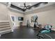 Well-equipped home gym with stairs, rubber flooring, TV, and an array of exercise machines at 2447 Tift Nw Ct, Kennesaw, GA 30152
