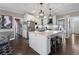 Open-concept kitchen featuring a large island, stainless steel appliances, and white shaker cabinets at 2447 Tift Nw Ct, Kennesaw, GA 30152