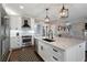 Modern kitchen with white cabinets, a center island with a sink, and stainless steel appliances at 2447 Tift Nw Ct, Kennesaw, GA 30152