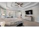 The main bedroom features a tray ceiling, ceiling fan, and an entertainment center for added convenience at 2447 Tift Nw Ct, Kennesaw, GA 30152