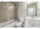 Clean bathroom with shower-tub combination, glass sliding doors, and a neutral color scheme at 2916 Kings Walk Ave, Marietta, GA 30062